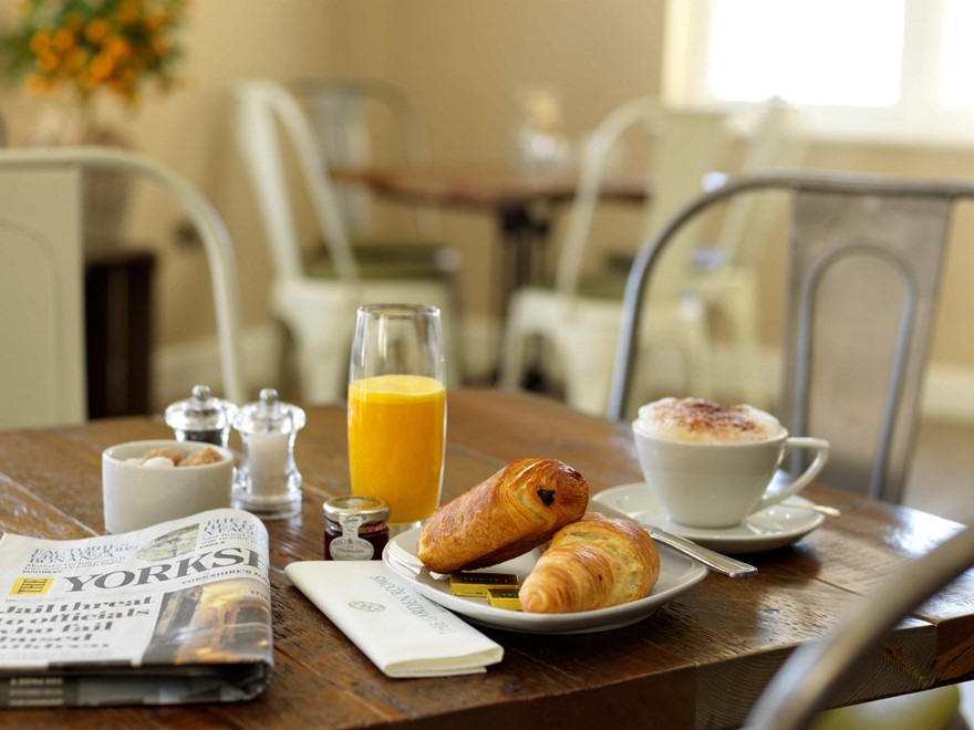 Breakfast pastries, orange juice and coffee served in the Cafe