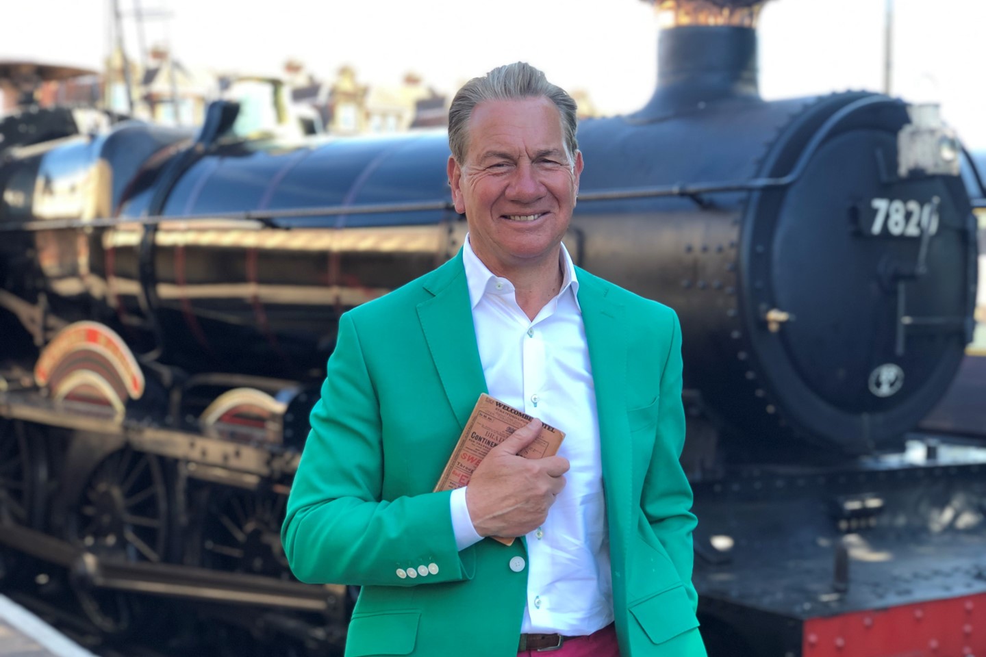 Michael Portillo in front of a steam engine