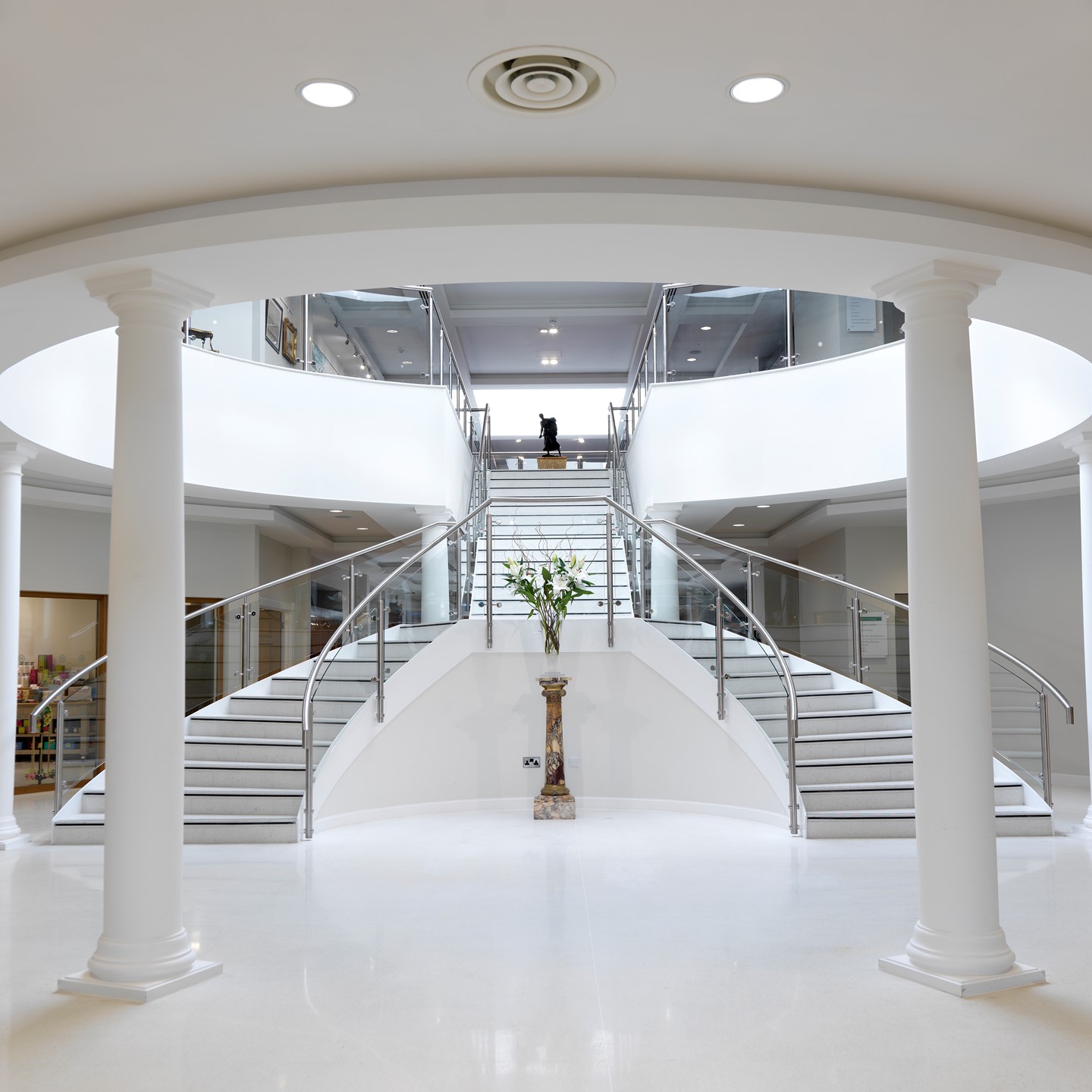 Garden Rooms entrance in the reception area, with the double staircase and white pillars