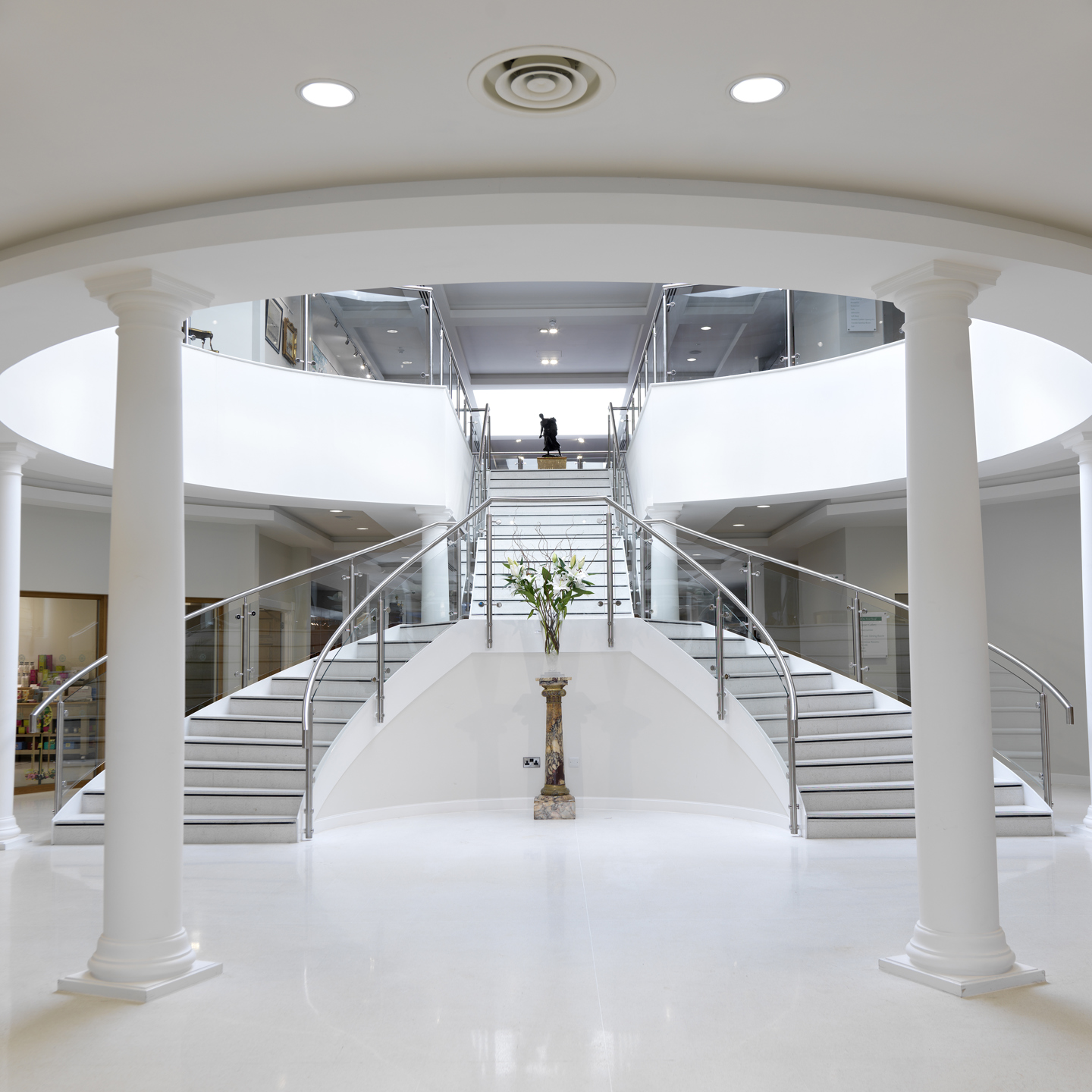 Garden Rooms entrance in the reception area, with the double staircase and white pillars