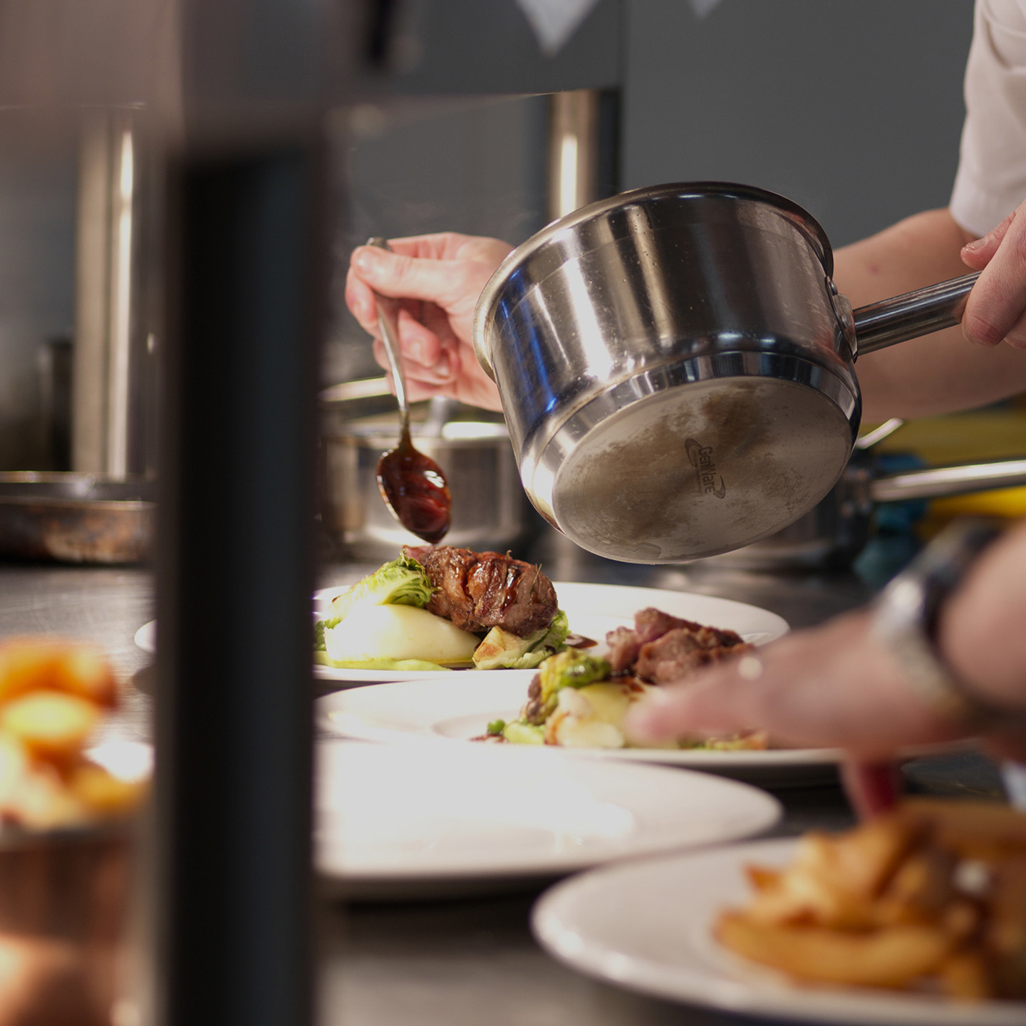 Chef plating dishes in the kitchen