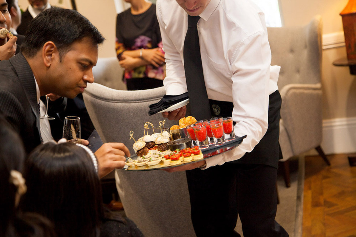 Wedding guests choosing canapes 